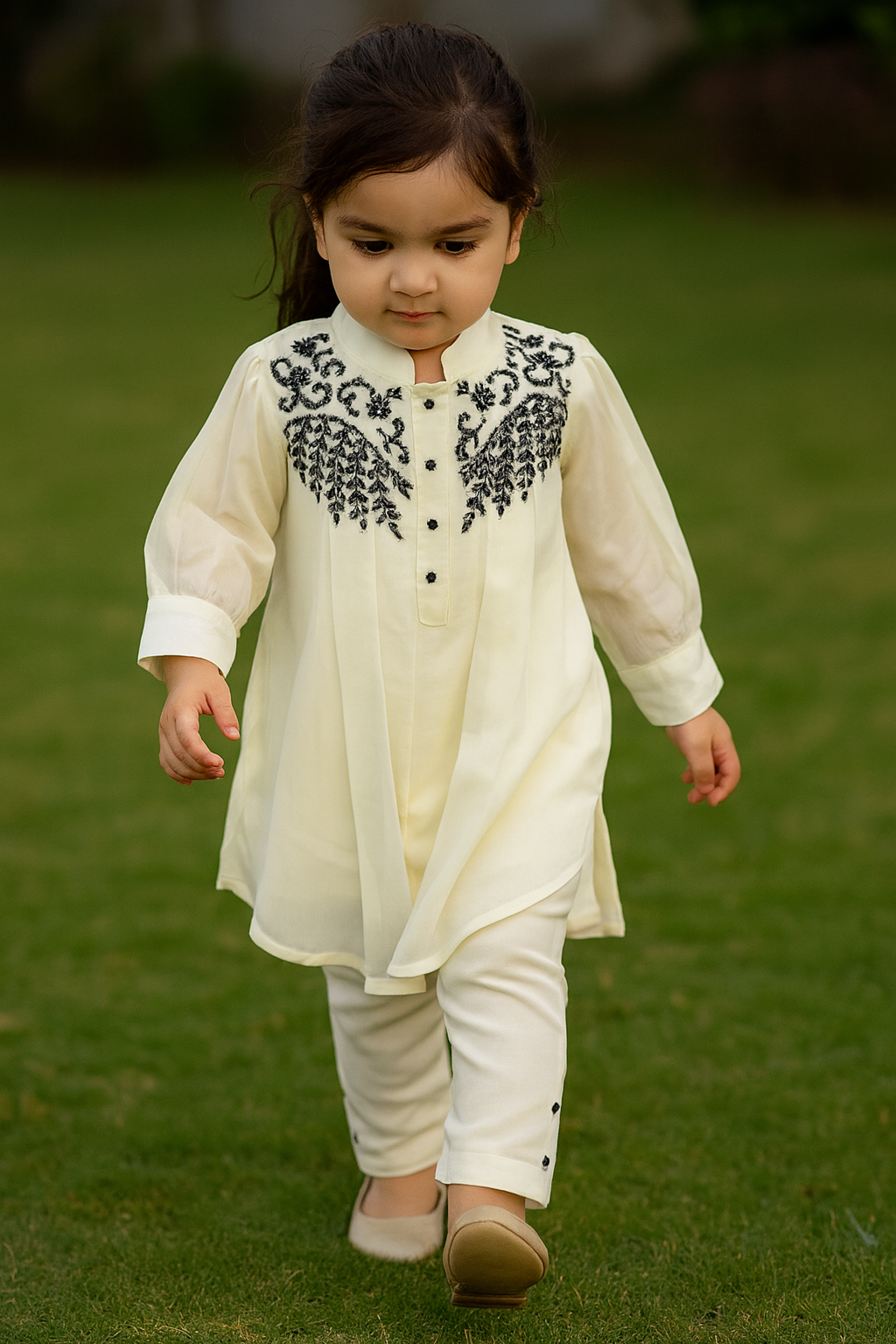 Stylish asymmetrical kurti and pant with hand-embroidered black thread and beadwork on the yoke