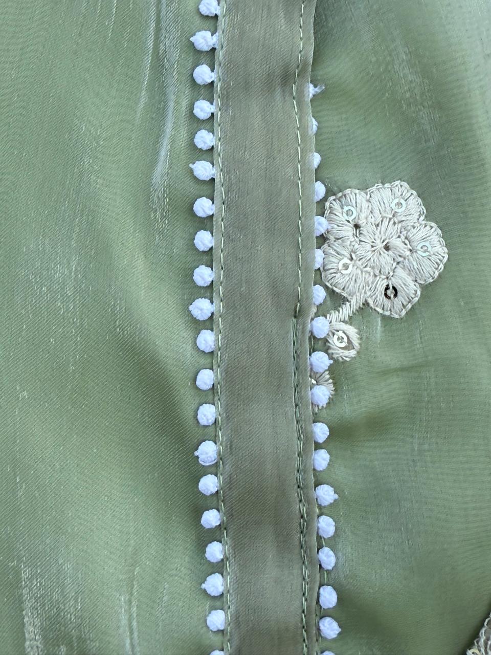 Elegant sage green embroidered set with pearl accents and lace-detailed pants and dupatta.