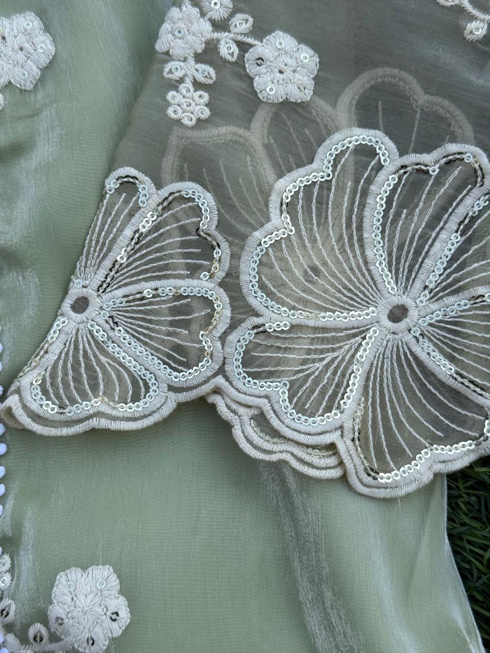 Elegant sage green embroidered set with pearl accents and lace-detailed pants and dupatta.
