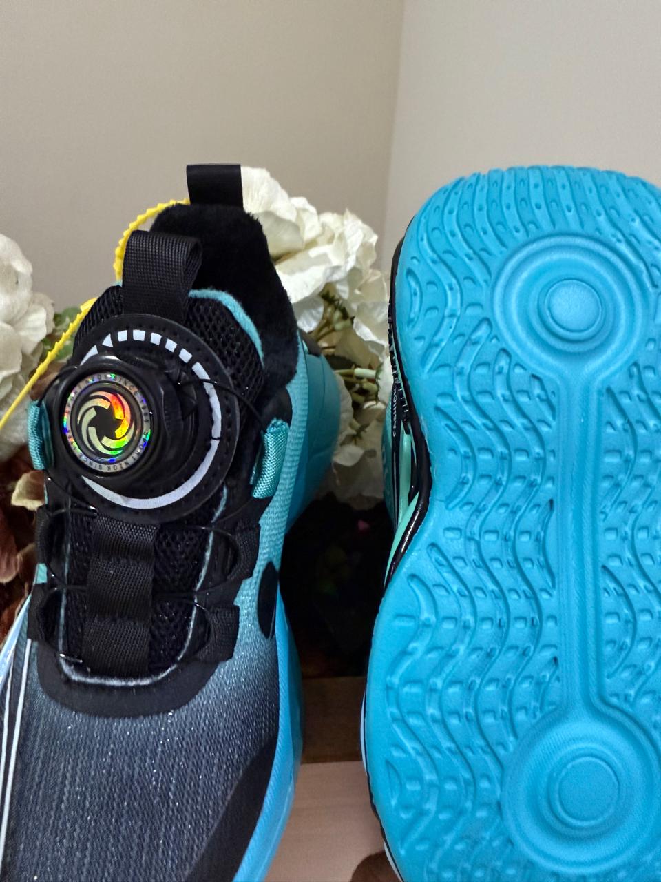Bold turquoise-black sneakers with futuristic soles, perfect for your little explorer.