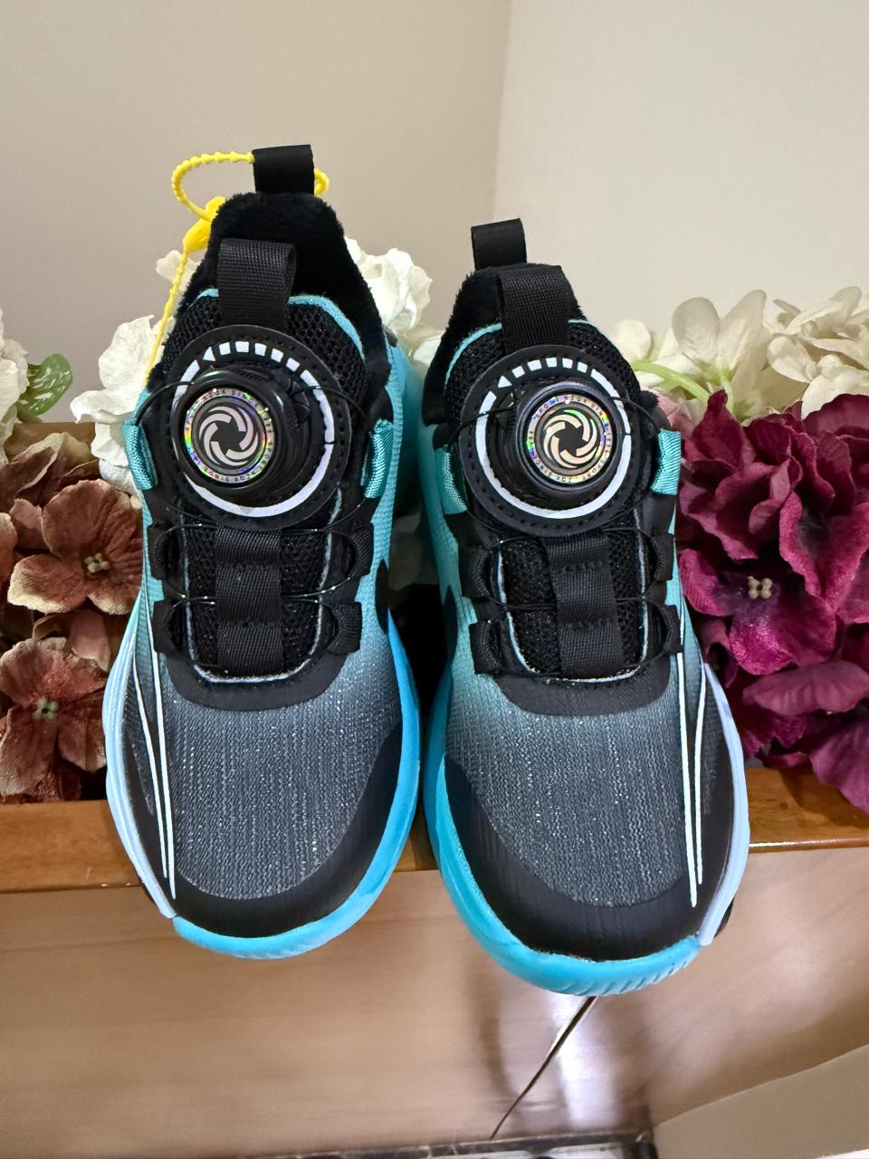 Bold turquoise-black sneakers with futuristic soles, perfect for your little explorer.