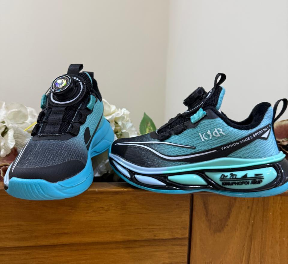 Bold turquoise-black sneakers with futuristic soles, perfect for your little explorer.