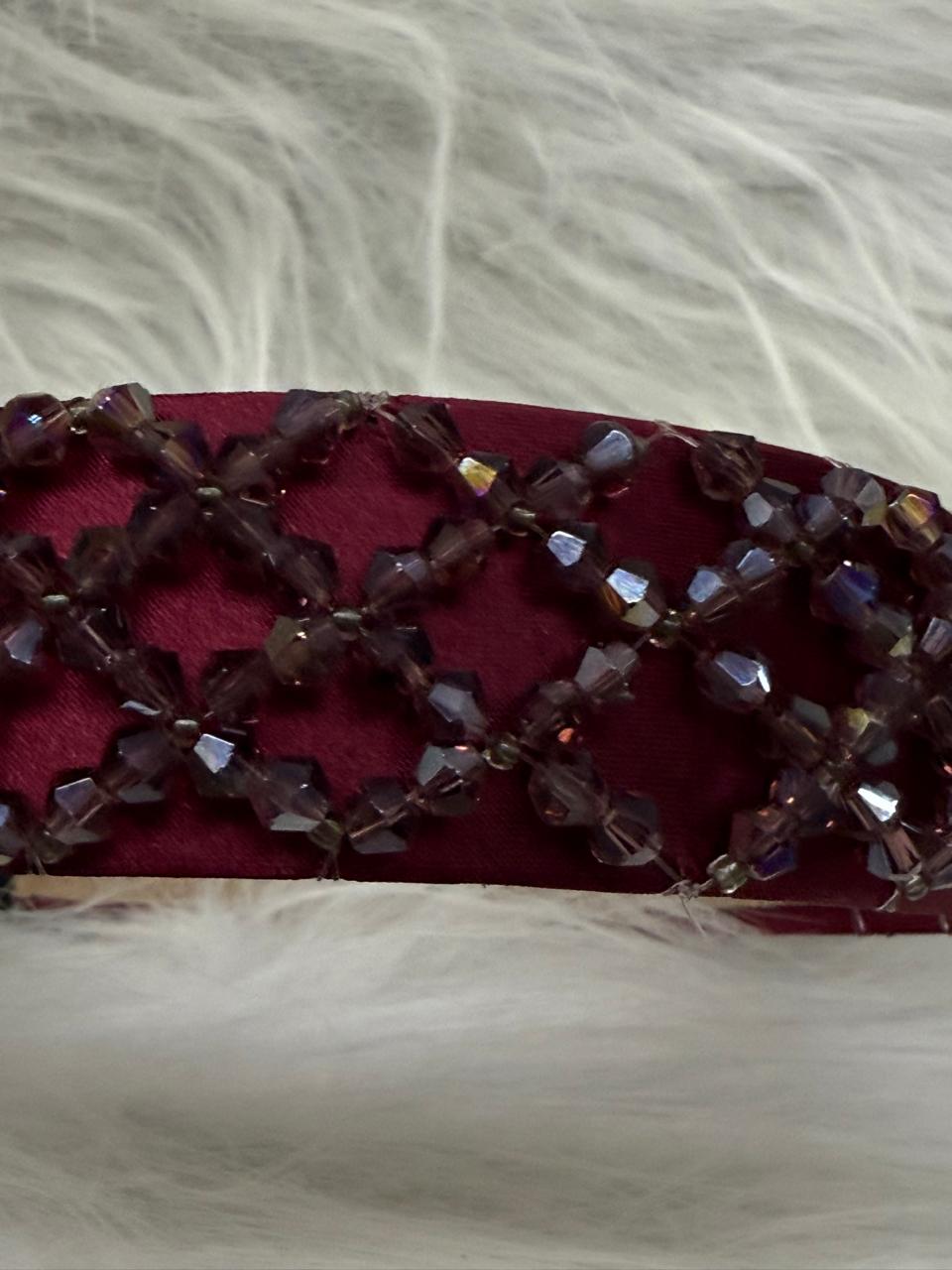 "Shine with elegance – a navy satin beaded headband that completes every look."