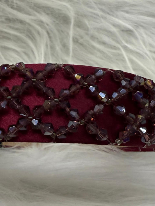 "Shine with elegance – a navy satin beaded headband that completes every look."