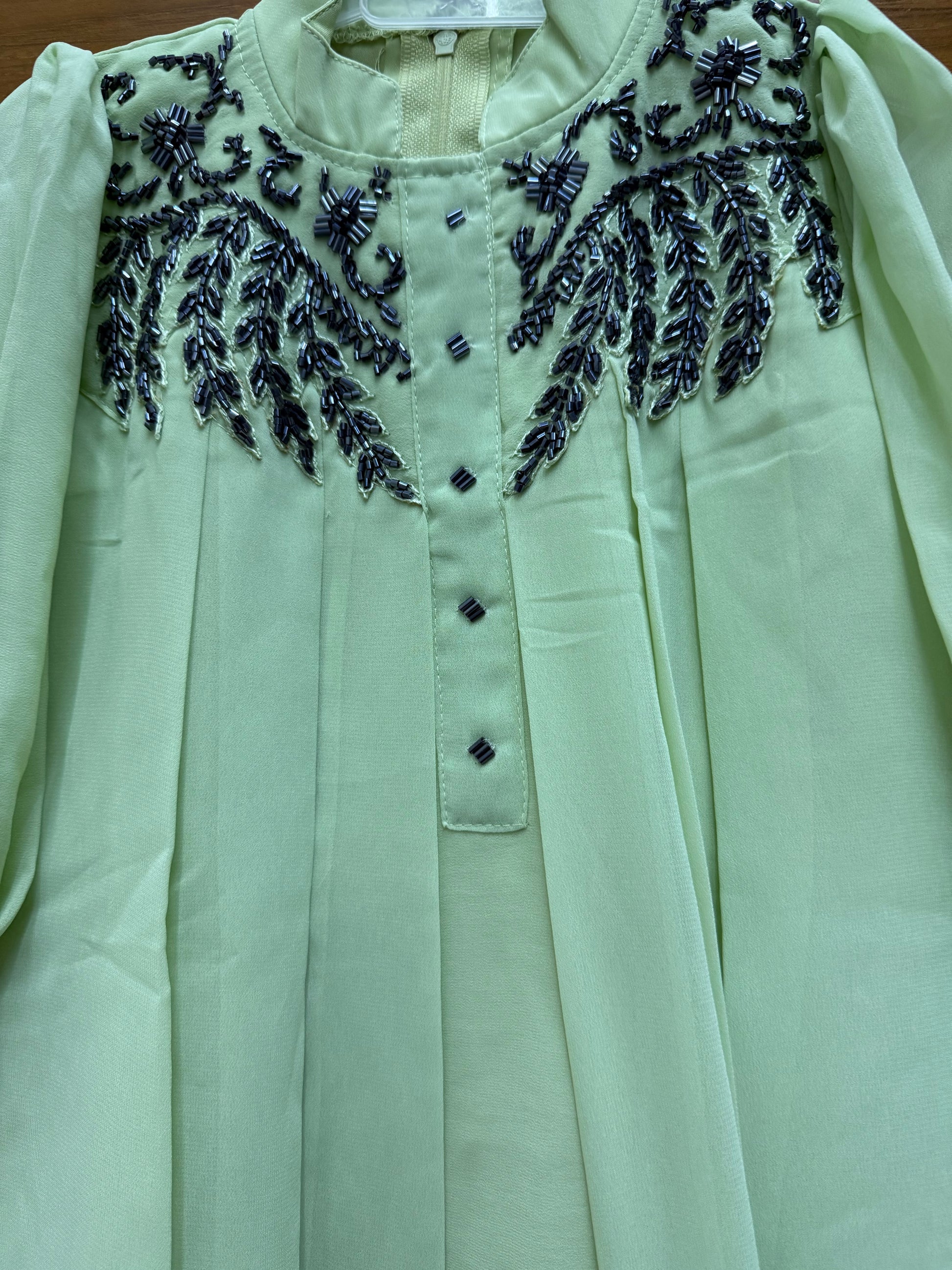 Stylish asymmetrical kurti and pant with hand-embroidered black thread and beadwork on the yoke