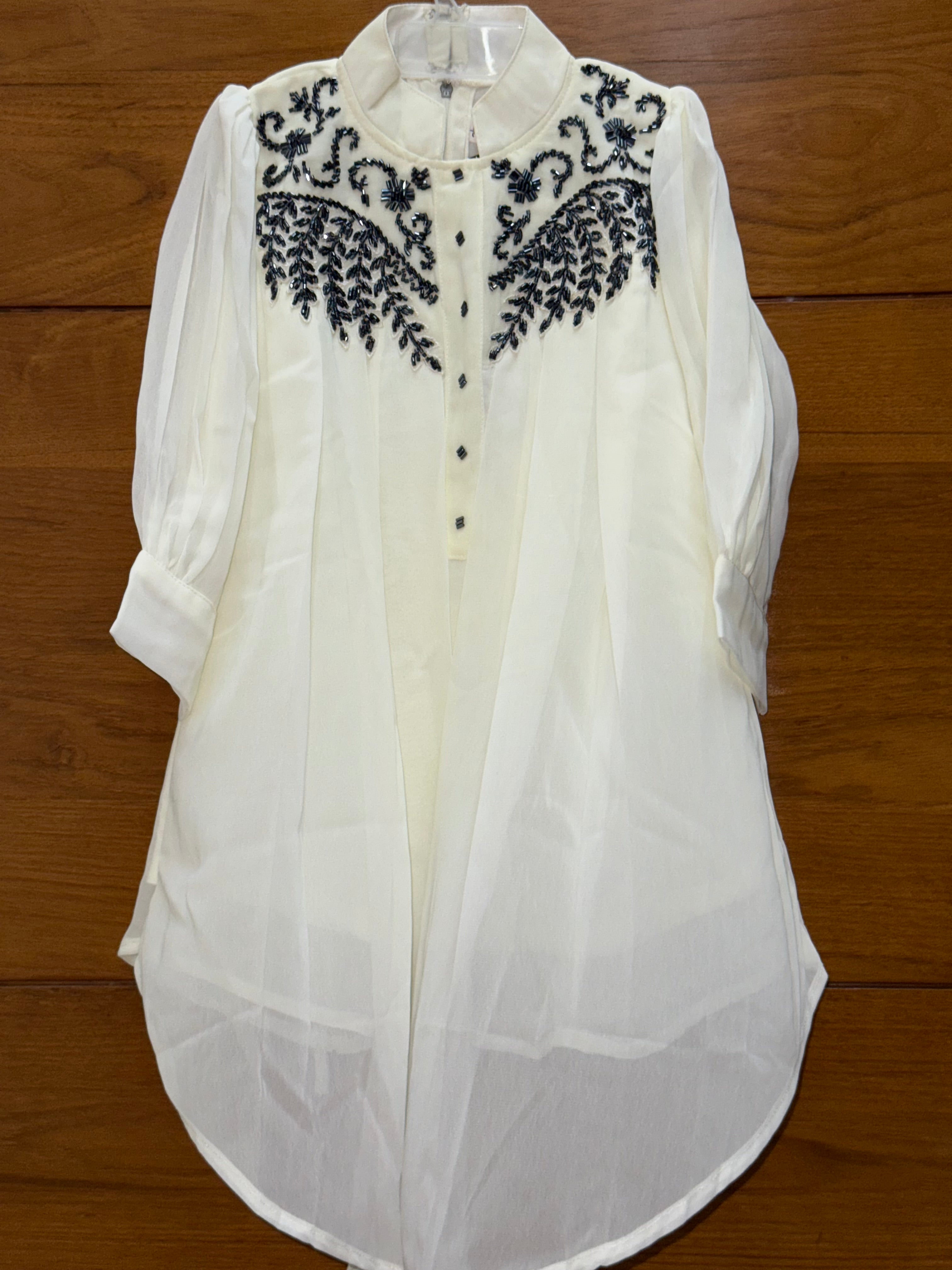 Stylish asymmetrical kurti and pant with hand-embroidered black thread and beadwork on the yoke