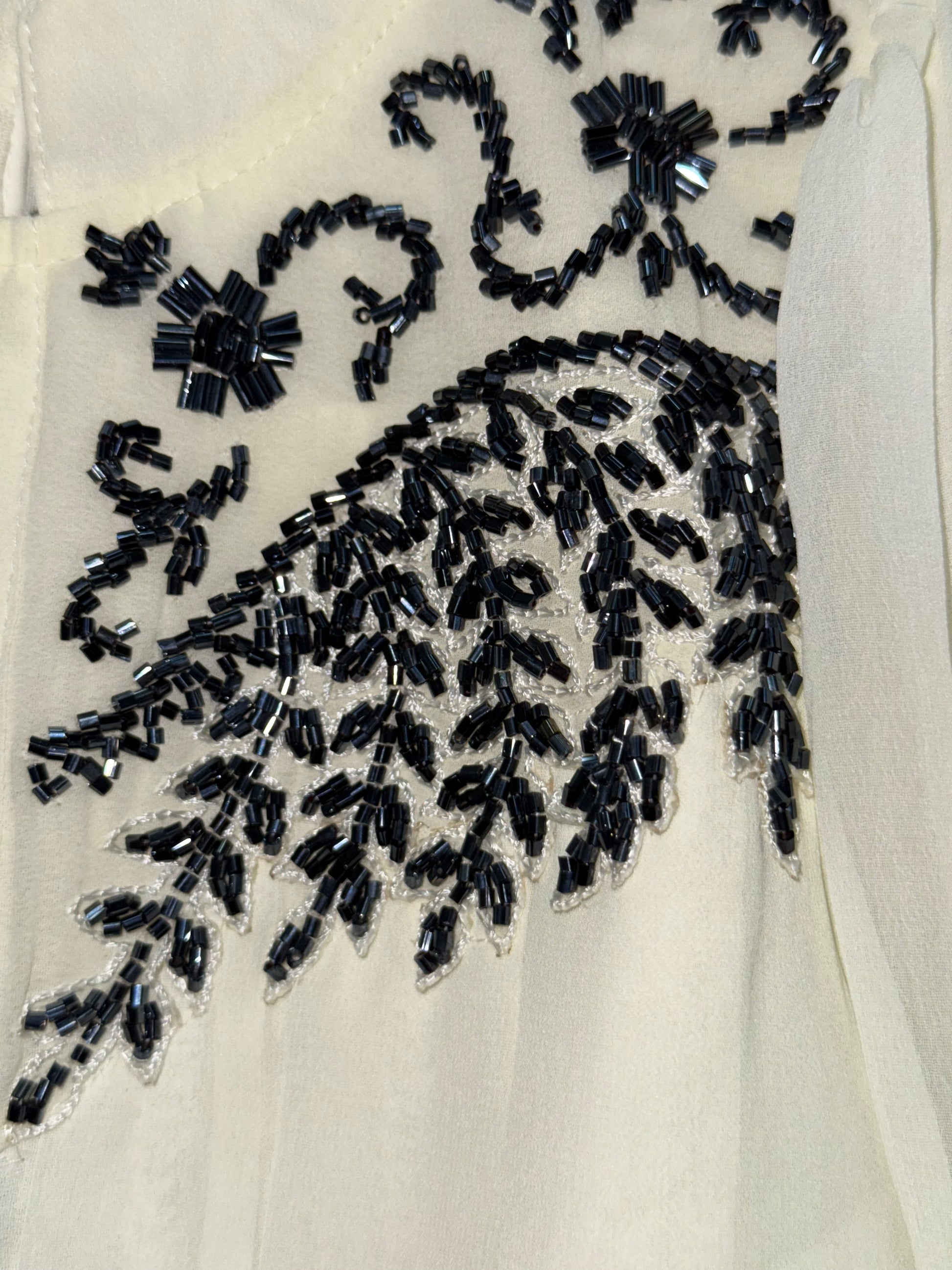 Stylish asymmetrical kurti and pant with hand-embroidered black thread and beadwork on the yoke
