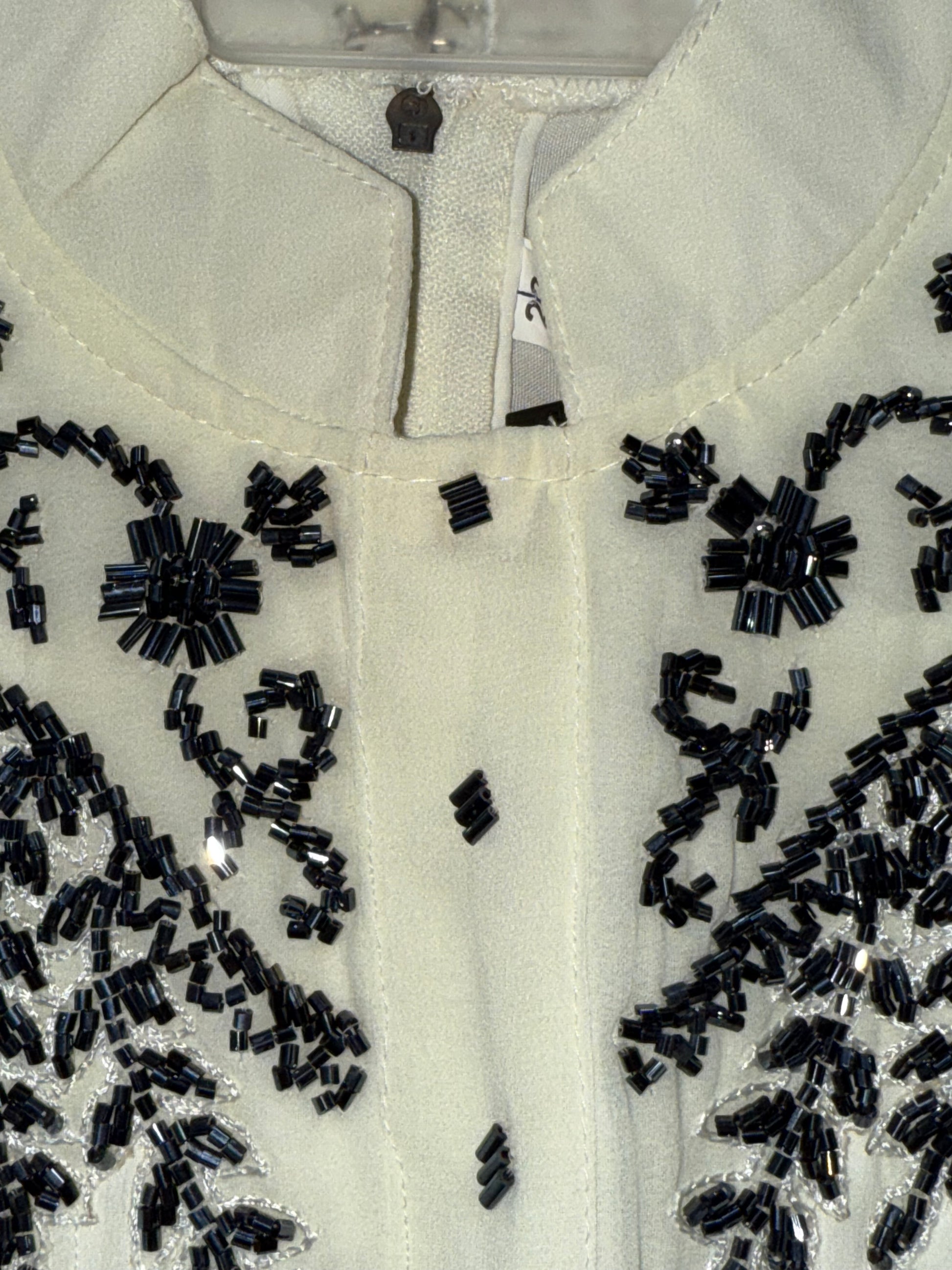 Stylish asymmetrical kurti and pant with hand-embroidered black thread and beadwork on the yoke