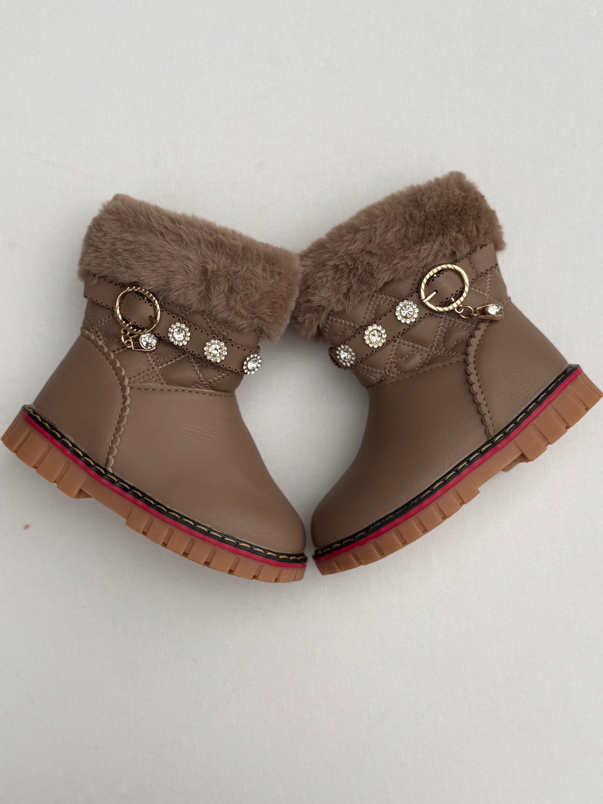 Cozy black winter boots with plush fur lining, pearl-studded strap, and golden.