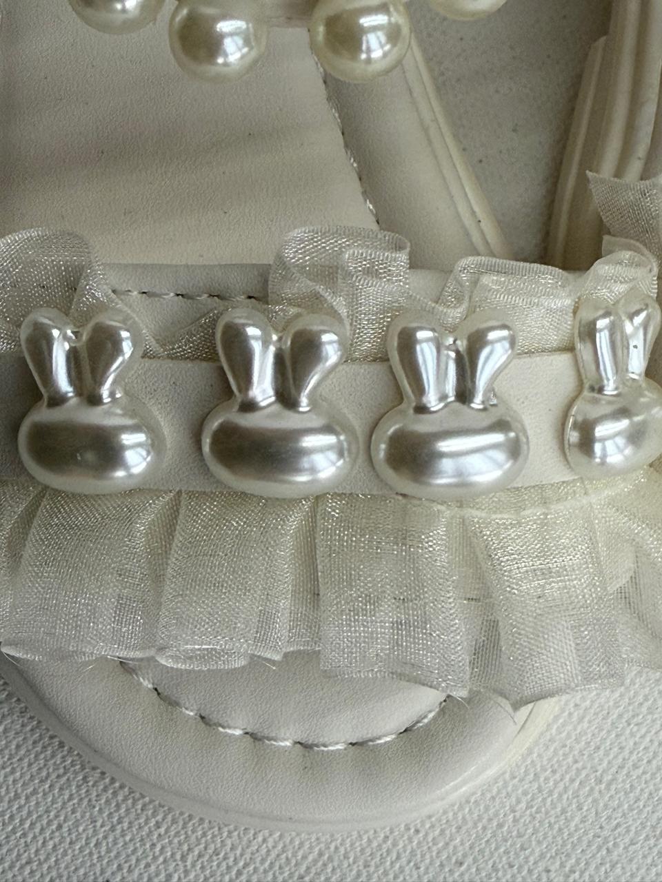 Step into cuteness with our pearl bunny ruffle sandals!"