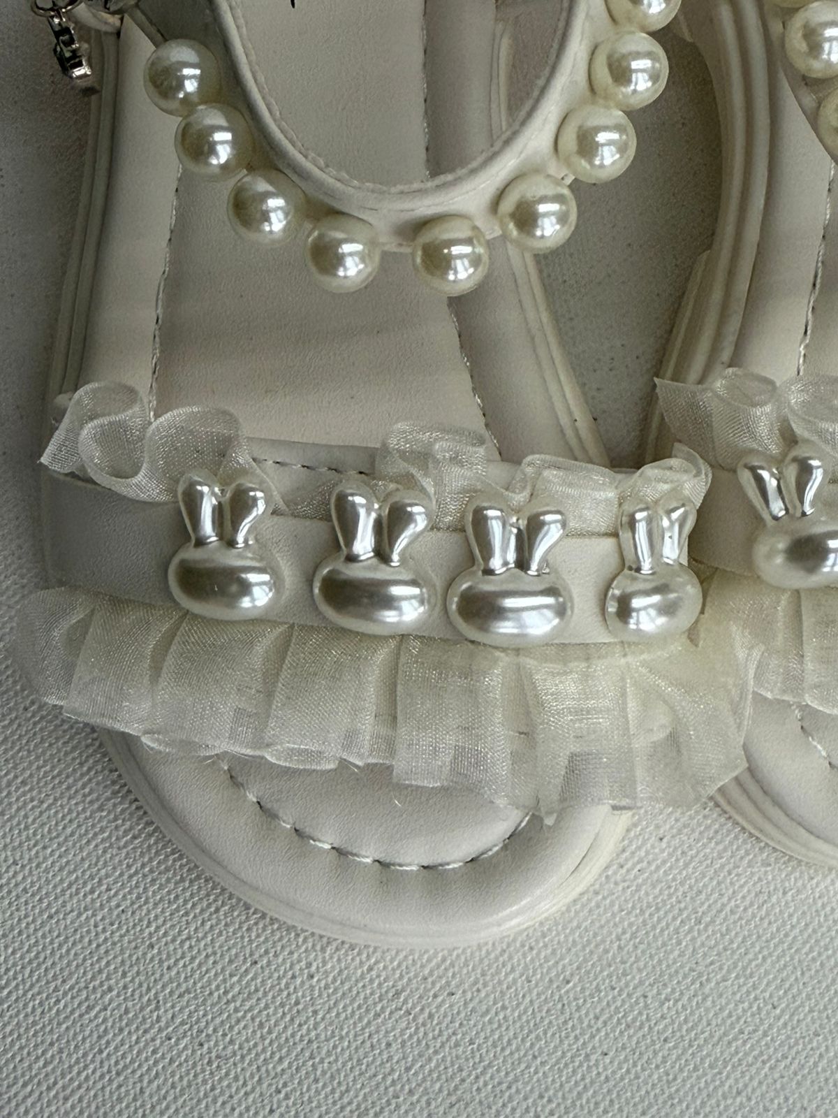 Step into cuteness with our pearl bunny ruffle sandals!"