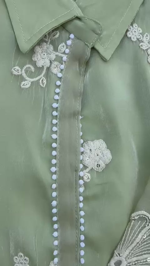 Load video: Elegant sage green embroidered set with pearl accents and lace-detailed pants and dupatta.
