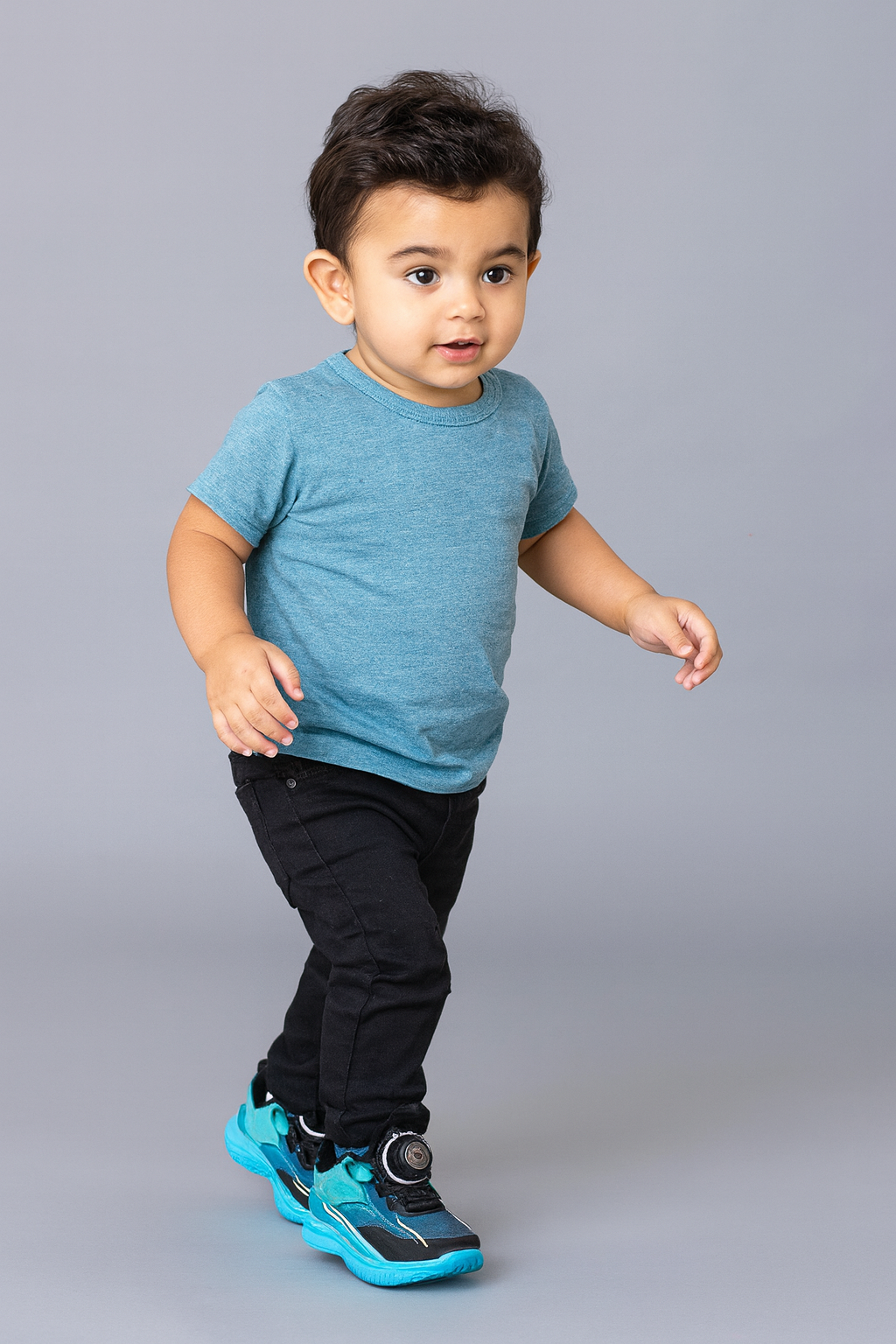 Bold turquoise-black sneakers with futuristic soles, perfect for your little explorer.
